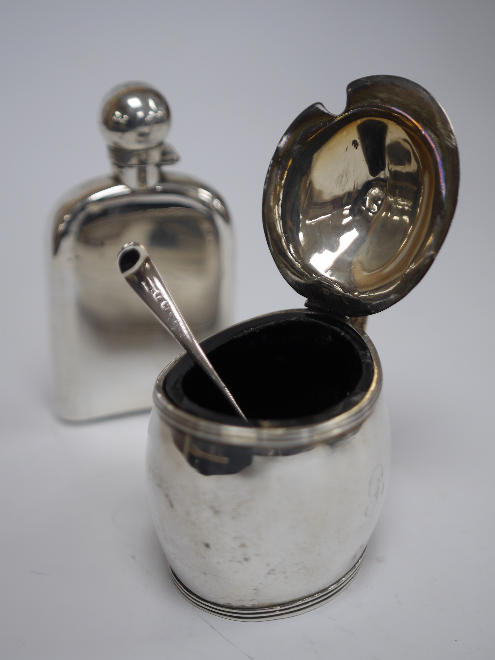 A late Victorian silver hip flask, with engraved monogram, by George Brace, London, 1884, 12.7cm (lead patch), together with a George III silver oval mustard, by Charles Fox & James Turner, London, 1802, (a.f.), with ass